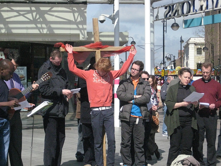 A man being put on a cross during a walk of witness
