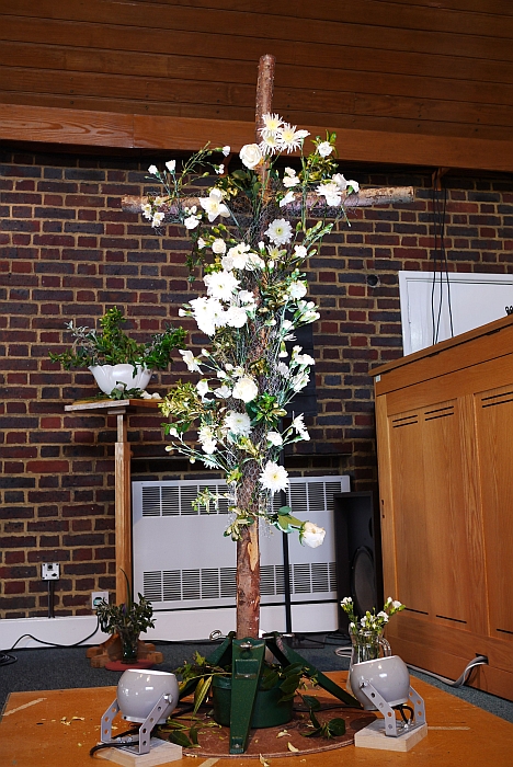 A cross covered with white flowers