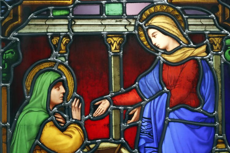 A stained glass window depicting Mary visiting Elizabeth