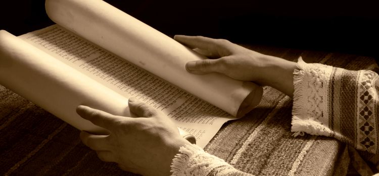 Hands holding an old scroll