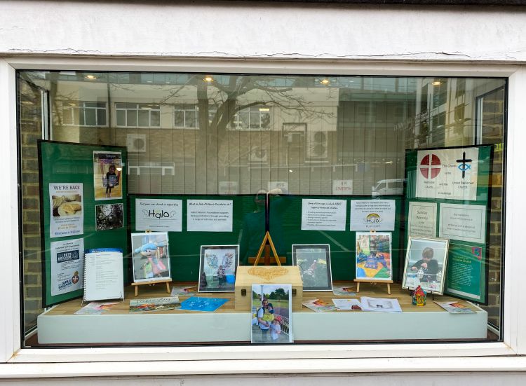 The church window display for Halo Children's Foundation with a memory box, bereavement books, leaflets and photos of Halo activities