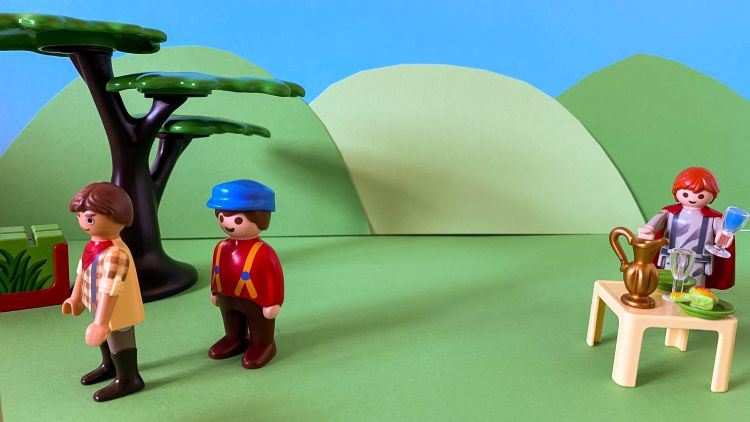 A Playmobil scene depicting the story of the prodigal son with the prodigal son feasting while the father talks to the elder son