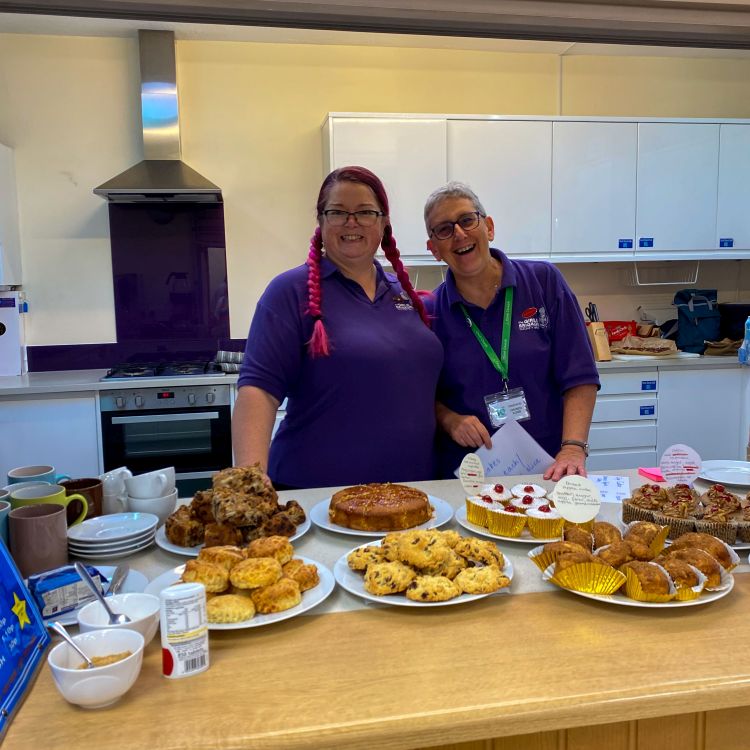 Two Girls' Brigade officers with cakes ready for the coffee morning