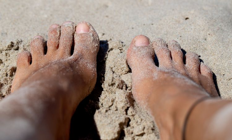 Sandy feet on a beach
