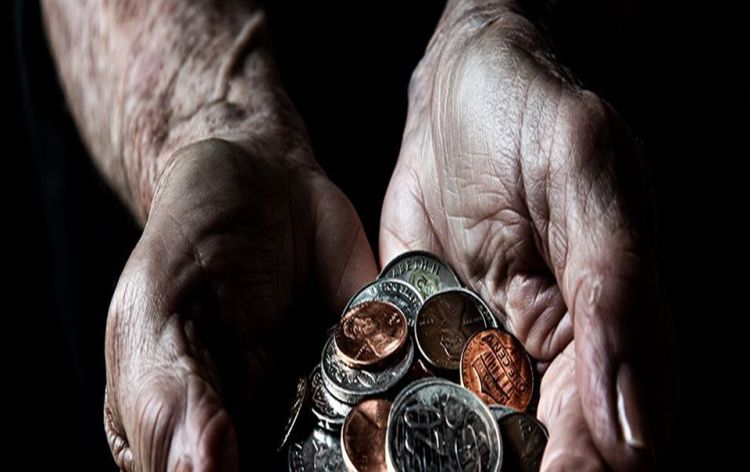 Cupped hands holding a handful of coins