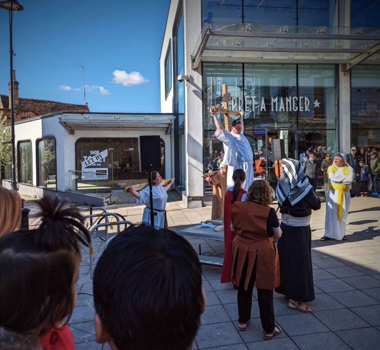 A Passion Play being performed in Uxbridge town centre with actors depicting Jesus on the cross with the two thieves either side.